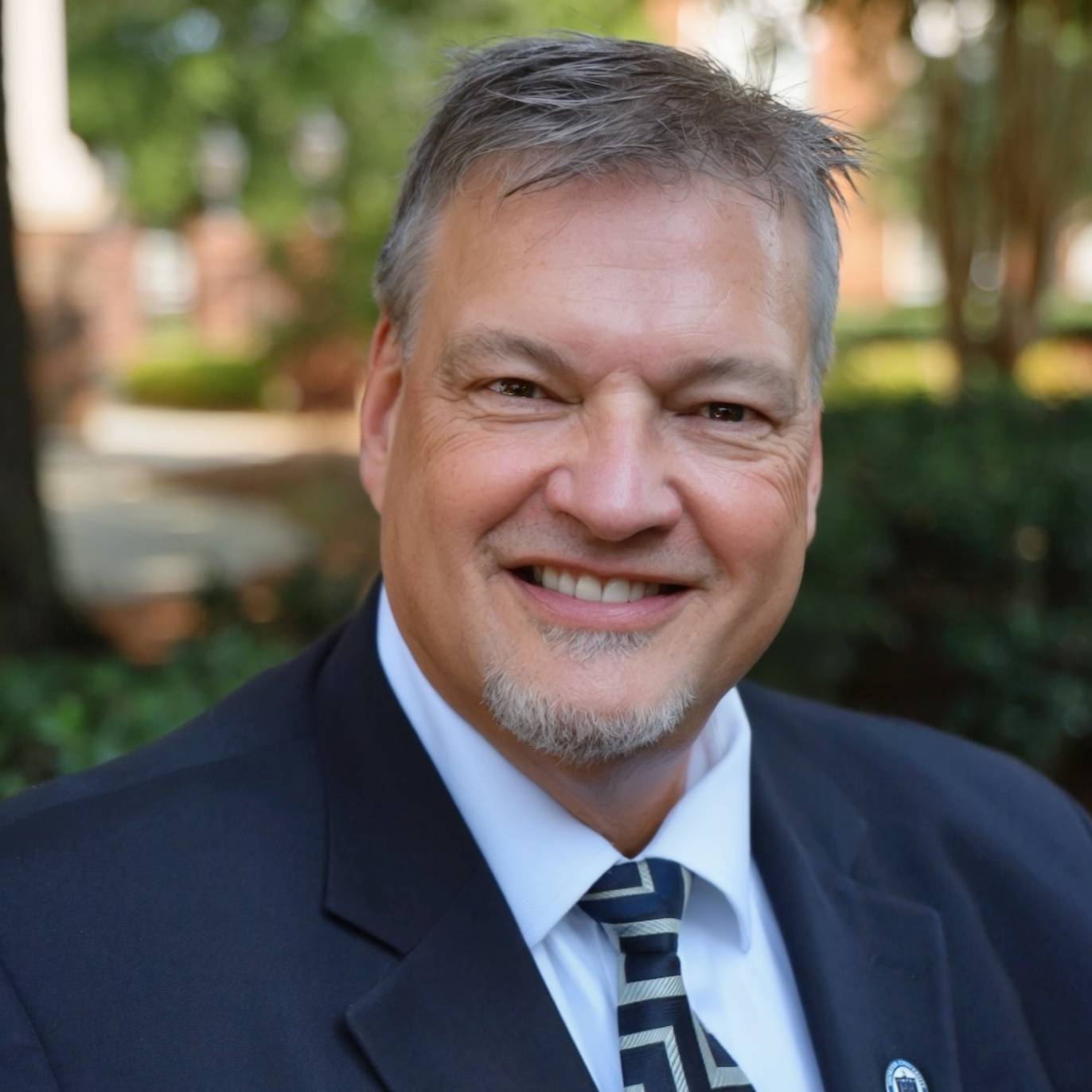 man in blazer smiling