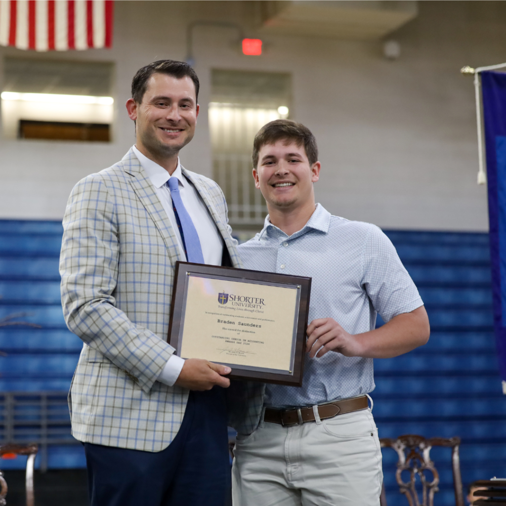 Barrett Saunders and Dr. Heath Hooper standing with award.