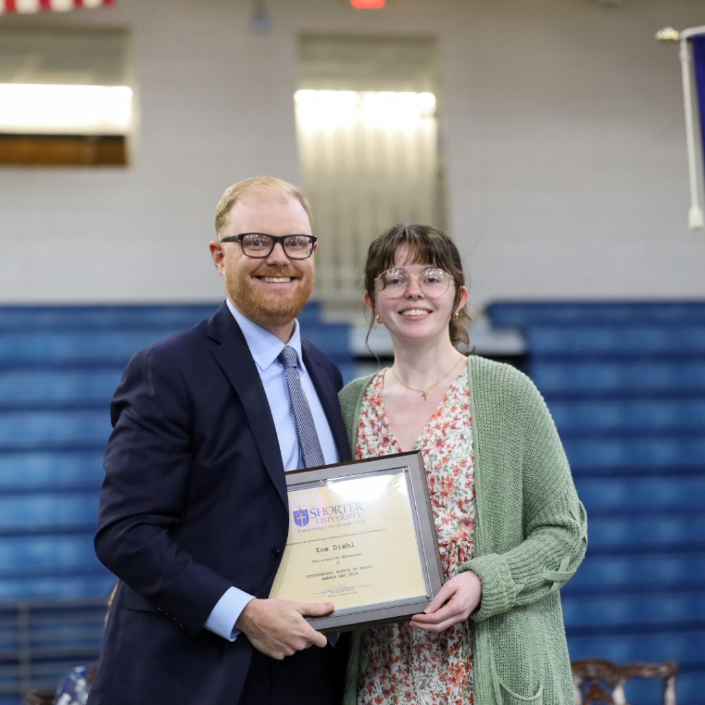 Dr. John McCluskey and Zoe Diehl standing with the award.