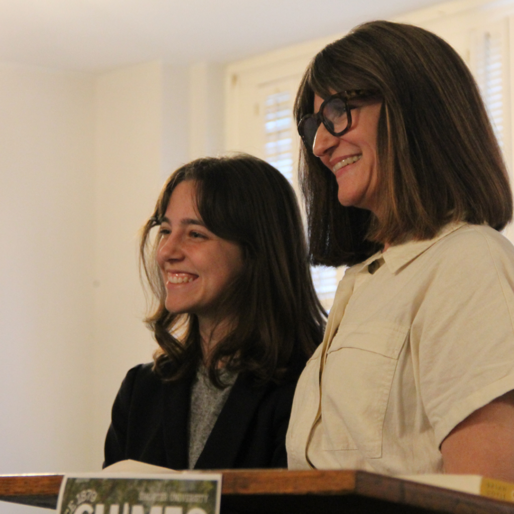 Professor and student smiling