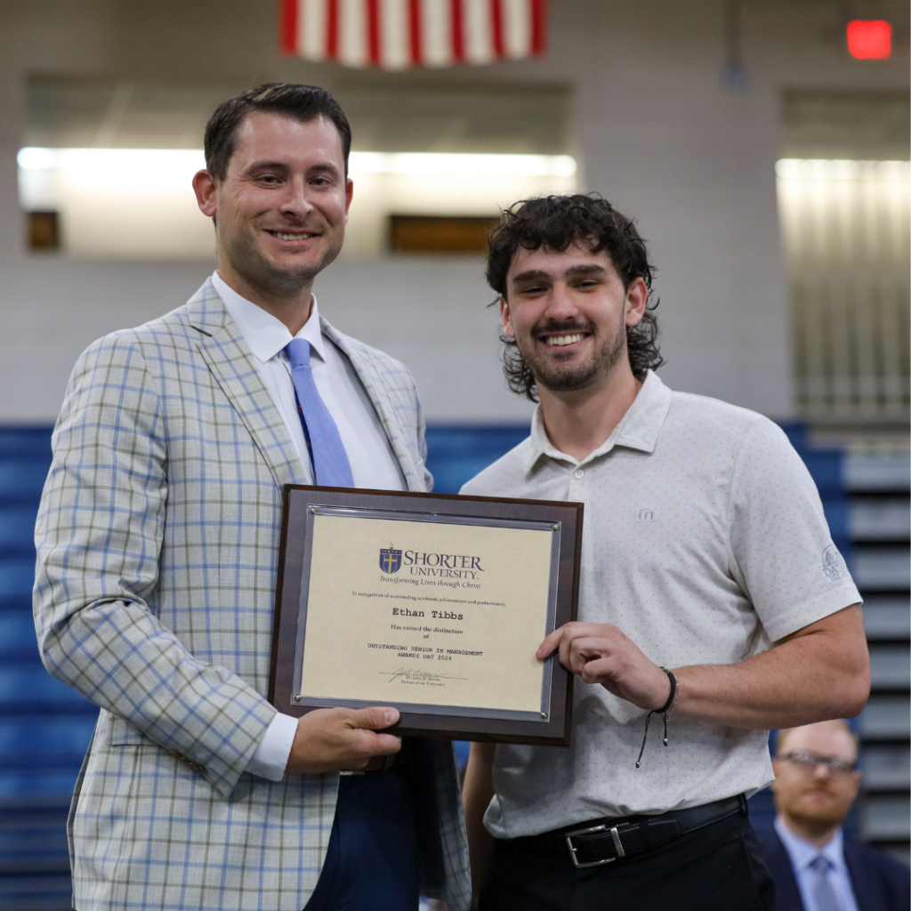 Dr. Heath Hooper and Ethan Tibbs standing with award