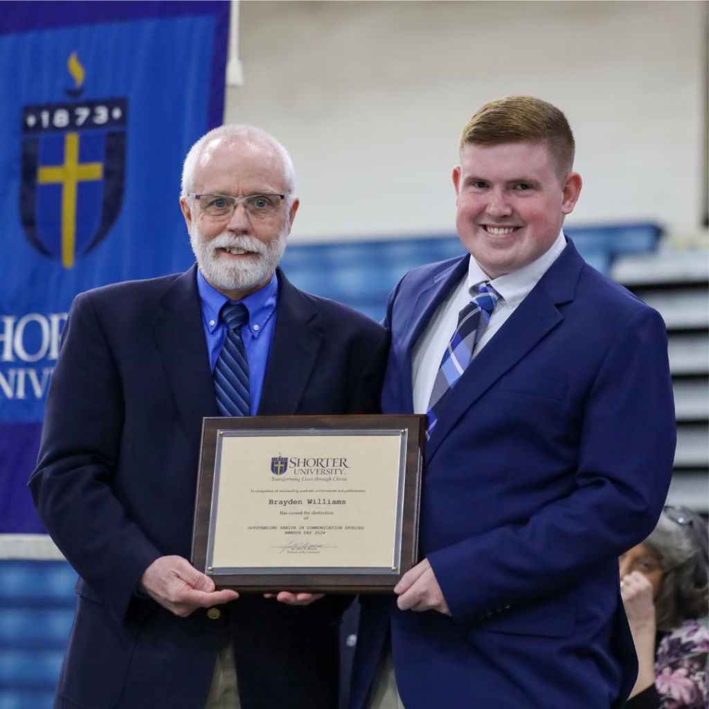 Dr. Earl Kellett and Brayden Williams standing with the award.