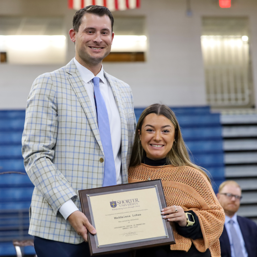 Dr. Heath Hooper and Maddalena LoRae standing with award.