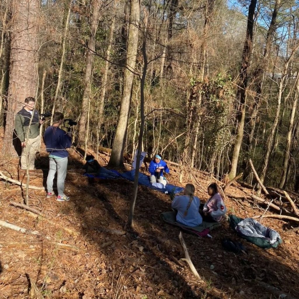 Cast and crew filming a scene