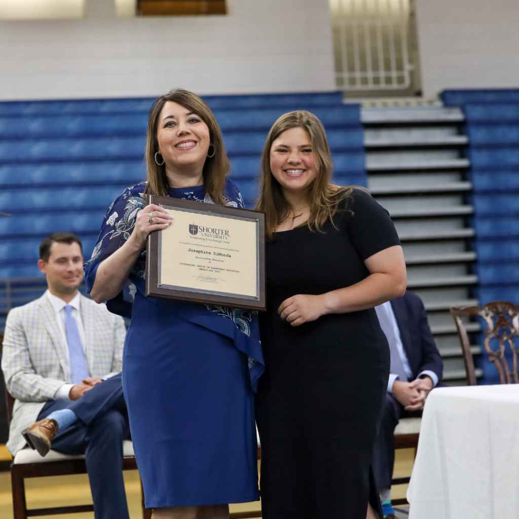 Dr. Dana King and Josephine DiMonda standing with award