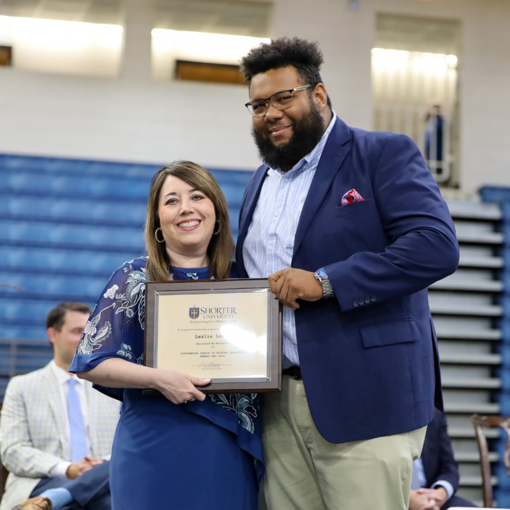 Dr. Dana King and Leslie Lewis standing with award