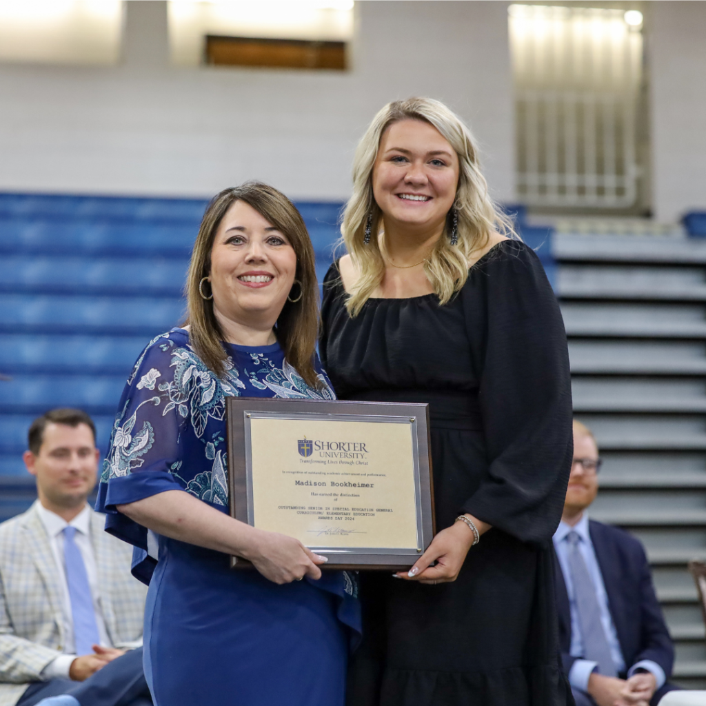 Dr. Dana King and Madison Bookheimer standing with award
