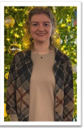 A person standing in front of a Christmas tree