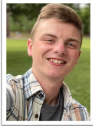 A young man smiling at the camera