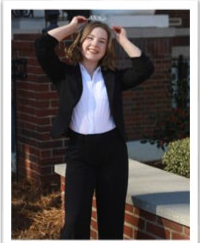 A young woman wearing a crown in a suit