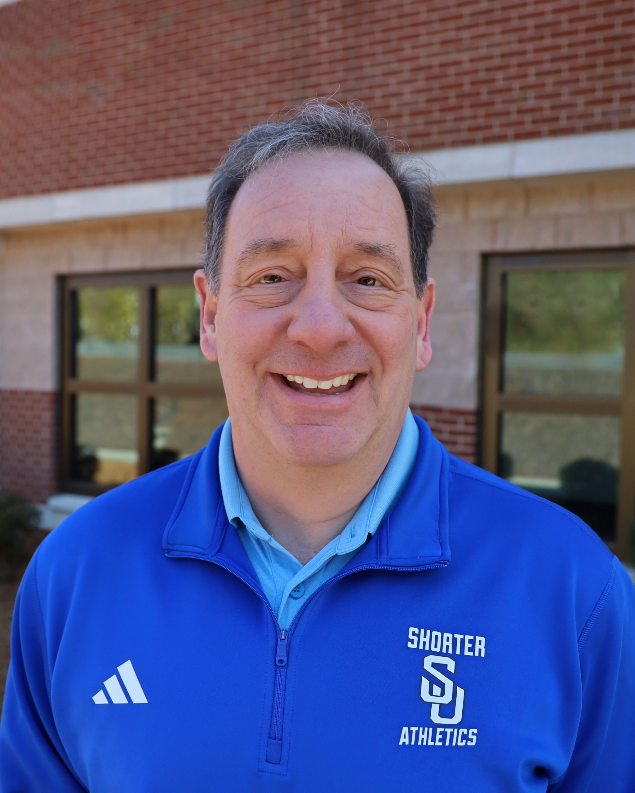 Man smiling with blue shirt