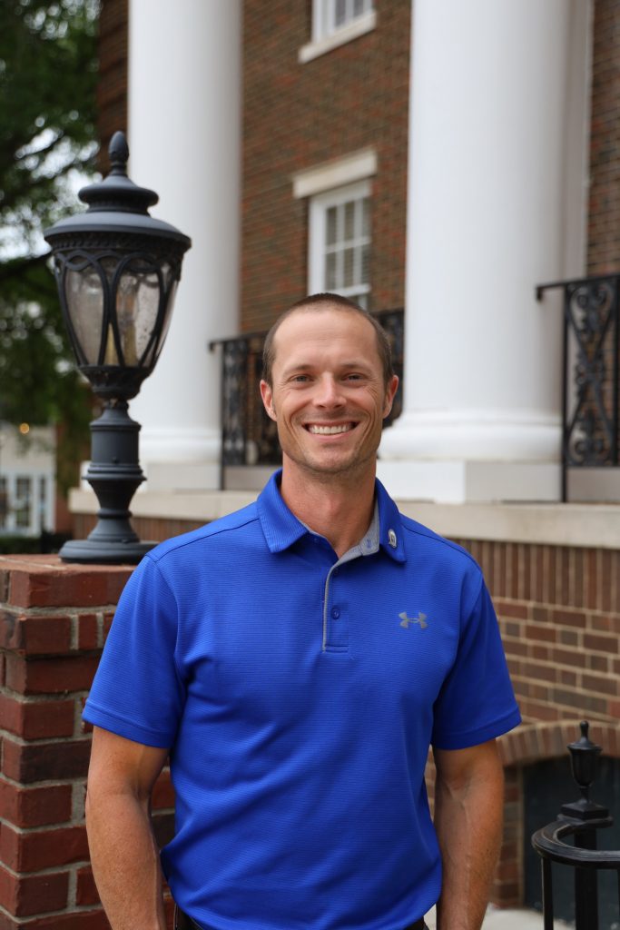 Man in blue shirt smiling