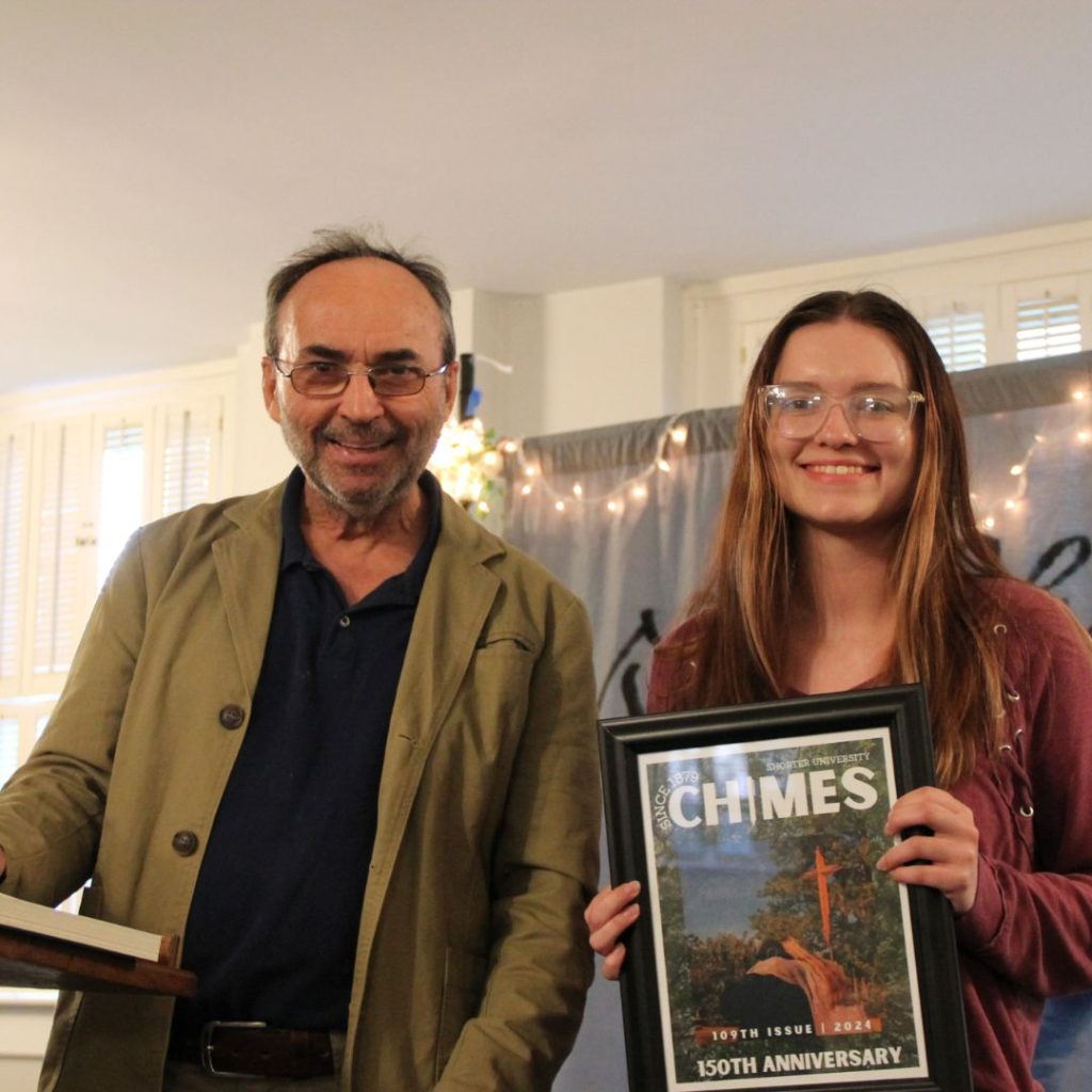 Professor and student smiling