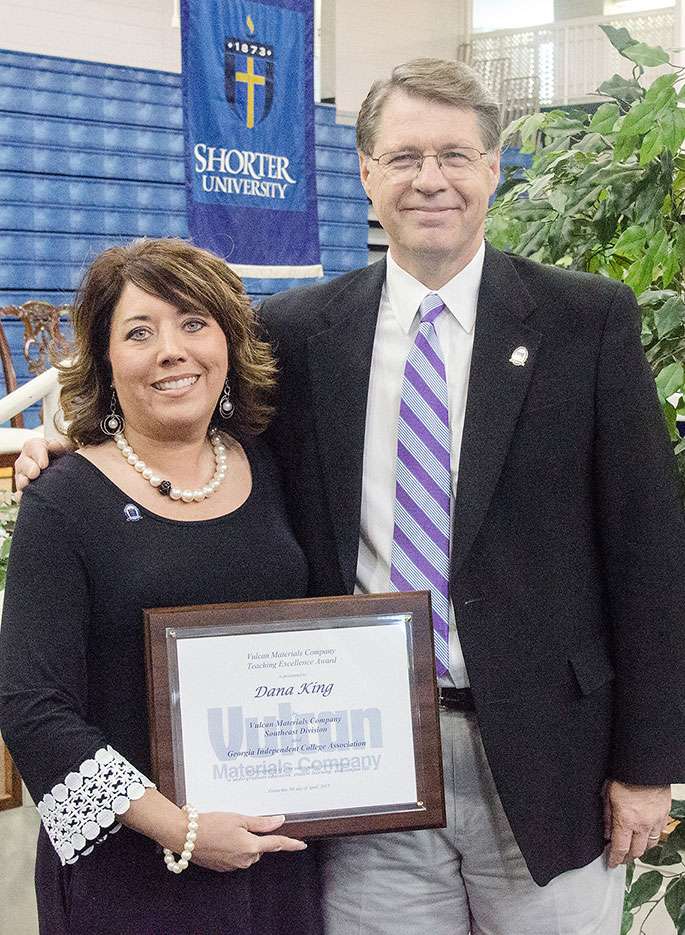 Dr. Dana King accepts her award from Dr. Don Dowless.